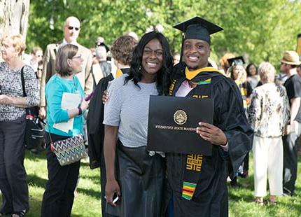 A male student and parent at Commencement